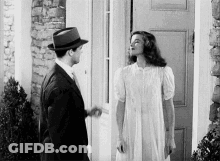 Man And Woman In Front Of Door GIF