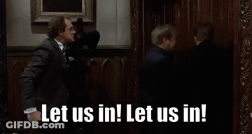 Man And Woman In Front Of Door Saying Let Us Out GIF