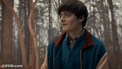 Man And Woman In Front Of Ferris Wheel GIF