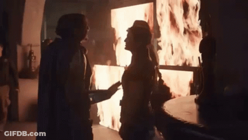 Man And Woman In Front Of Flame Screen GIF