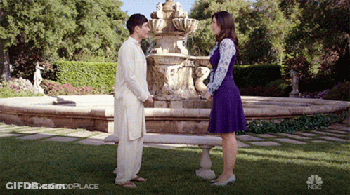 Man And Woman In Front Of Fountain Saying The Good Place GIF