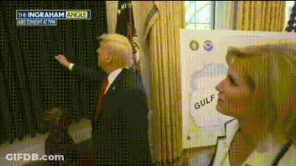 Man And Woman In Front Of Gulf Sign GIF