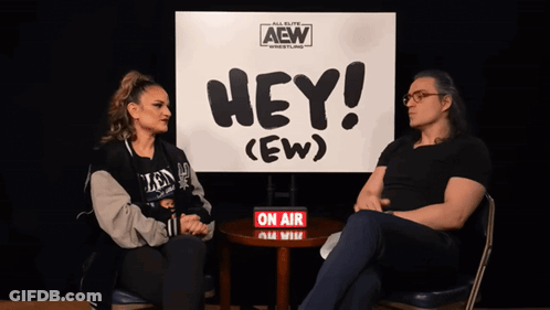 Man And Woman In Front Of Hey Ew Sign GIF
