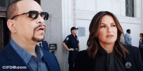 Man And Woman In Front Of NBC Building GIF