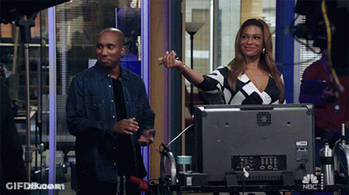 Man And Woman In Front Of NBC Monitor GIF