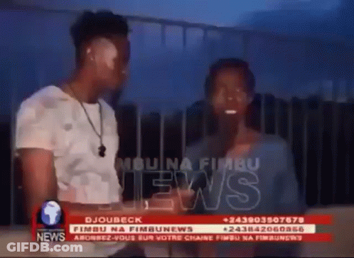 Man And Woman In Front Of News Screen GIF