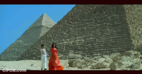 Man And Woman In Front Of Pyramid GIF