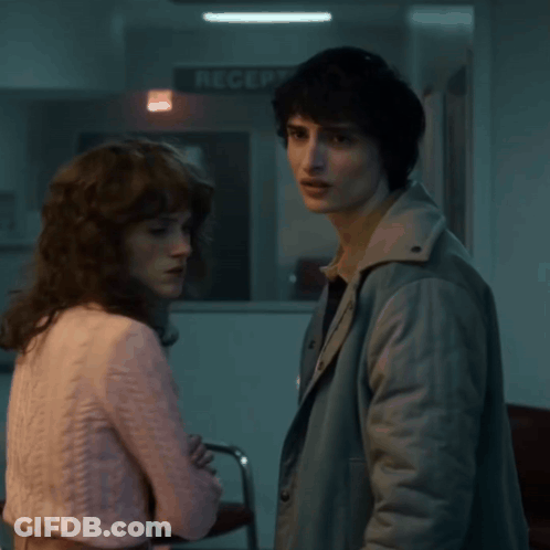 Man And Woman In Front Of Reception Sign GIF