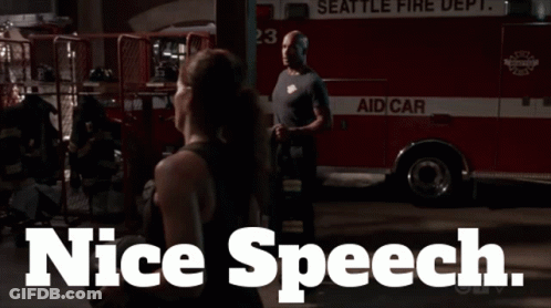 Man And Woman In Front Of Seattle Fire Truck GIF