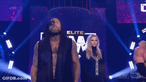 Man And Woman In Front Of Sign Saying A.T.E.W GIF