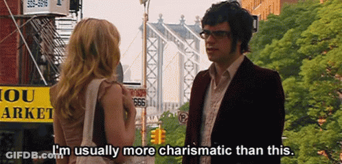 Man And Woman In Front Of Yellow Sign Saying 666 GIF