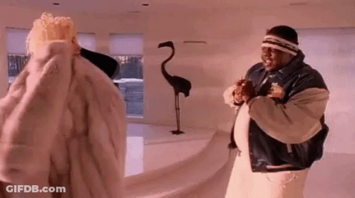 Man And Woman In Fur Coats In Living Room GIF