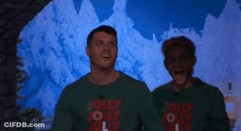Man And Woman In Green Sweaters Saying Jolly Jolly Jolly GIF