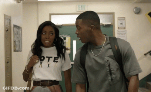 Man And Woman In Hallway With Exit Sign GIF