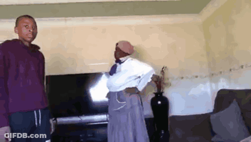 Man And Woman In Living Room With Flat Screen TV GIF