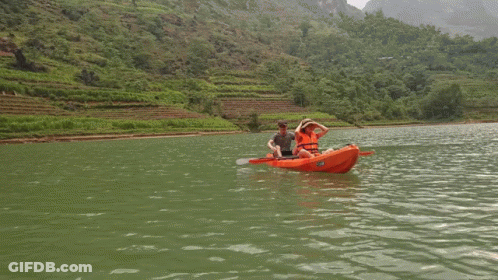 Man And Woman In Orange Kayak Saying Kayak GIF