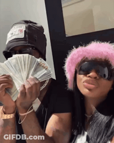 Man And Woman In Pink Hat Holding Money GIF