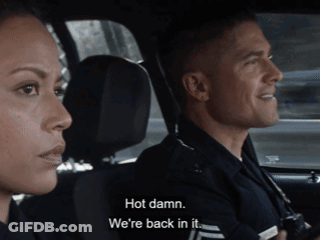 Man And Woman In Police Car Saying Hot Damn We're Back In It GIF