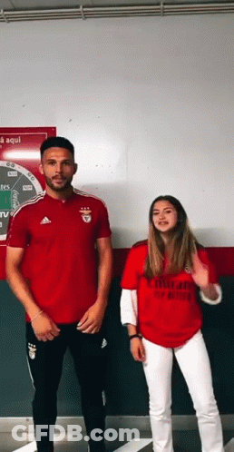 Man And Woman In Red Emirates Shirts GIF