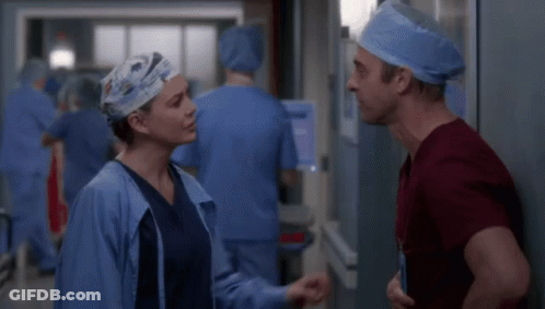Man And Woman In Scrubs Talking GIF