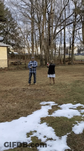 Man And Woman In Snowy Field GIF