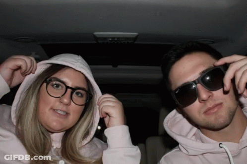 Man And Woman In Sunglasses And Hoodies GIF