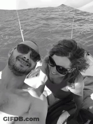 Man And Woman In Sunglasses Posing In Water GIF