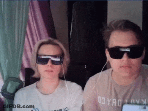 Man And Woman In Sunglasses Sitting Together GIF