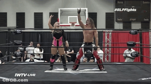 Man And Woman In Wrestling Ring Sponsored By IWTV GIF