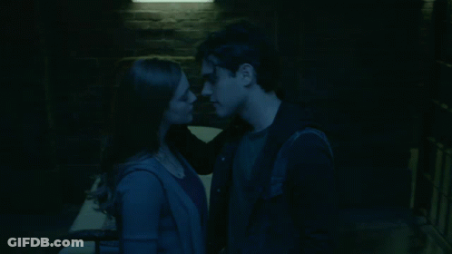 Man And Woman Kiss In Dark Room GIF