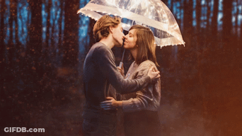 Man And Woman Kiss Under Umbrella Lights GIF