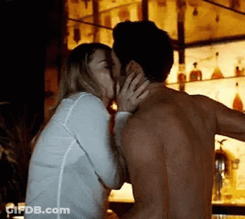 Man And Woman Kissing At Bar GIF