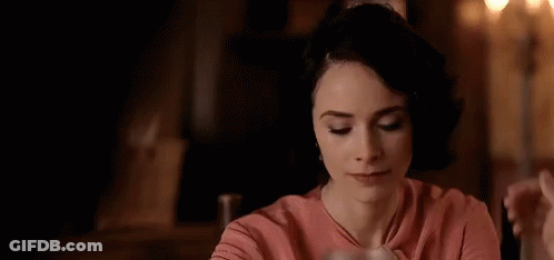 Man And Woman Kissing At Restaurant Table GIF