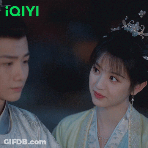 Man And Woman Kissing By IQYI Sign GIF