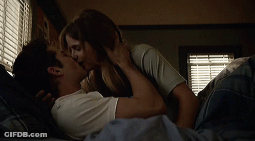 Man And Woman Kissing In Bed GIF