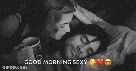 Man And Woman Kissing In Bed GIF
