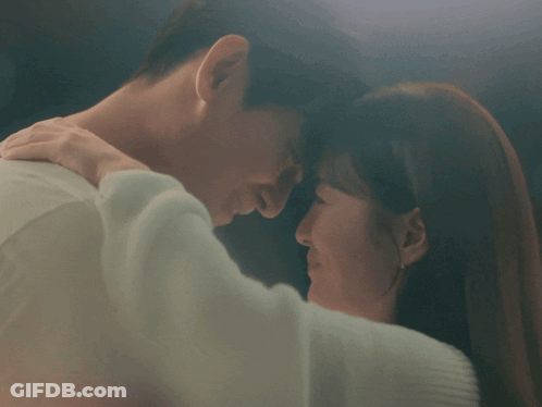 Man And Woman Kissing In Blurry Photo GIF
