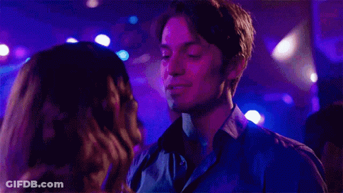 Man And Woman Kissing In Club With Purple Lights GIF