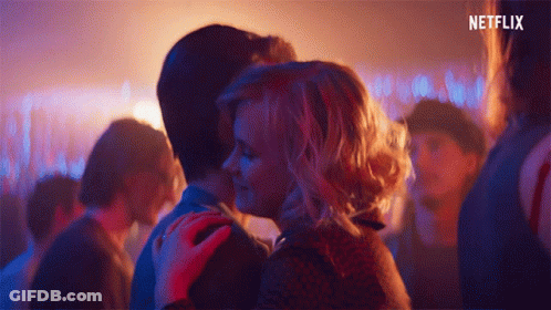 Man And Woman Kissing In Crowd With Netflix Logo GIF