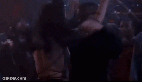 Man And Woman Kissing In Crowded Nightclub GIF