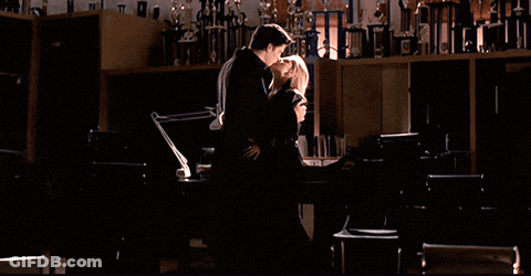 Man And Woman Kissing In Dark Room GIF