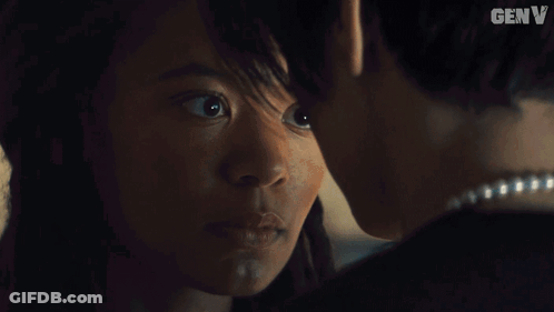Man And Woman Kissing In Dark Room With Word Genv GIF