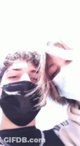 Man And Woman Kissing In Face Masks GIF