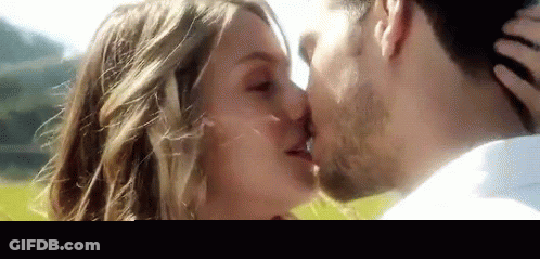 Man And Woman Kissing In Field GIF