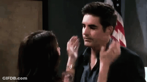 Man And Woman Kissing In Front Of American Flag GIF