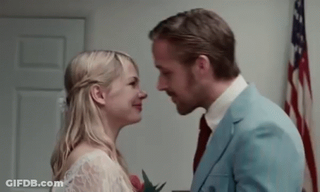 Man And Woman Kissing In Front Of American Flag GIF