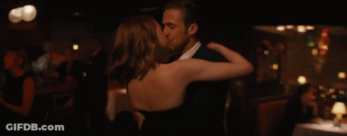 Man And Woman Kissing In Front Of Bar GIF