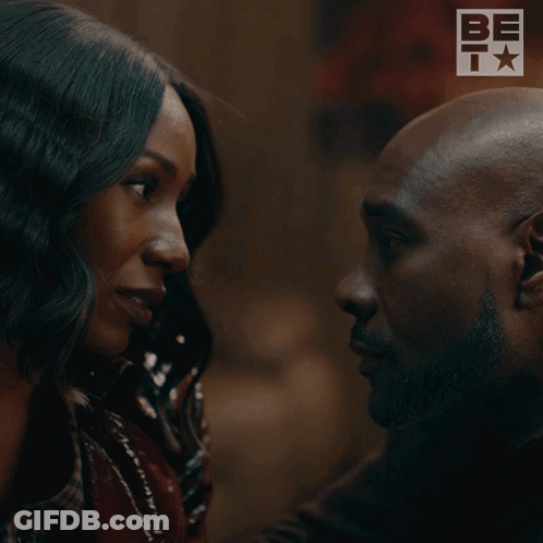 Man And Woman Kissing In Front Of Bet Logo GIF