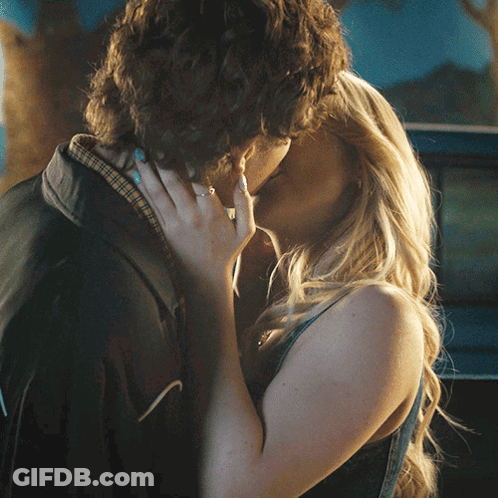 Man And Woman Kissing In Front Of Blue Car GIF