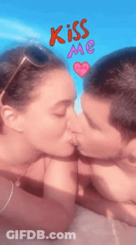 Man And Woman Kissing In Front Of Blue Sky And Pink Heart GIF